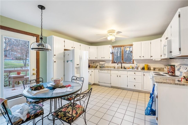 kitchen with white appliances, light tile patterned floors, ceiling fan, a sink, and backsplash