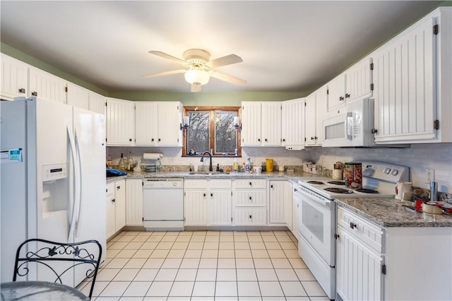 kitchen with white appliances, a ceiling fan, backsplash, and a sink