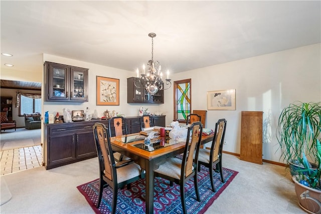 dining room with an inviting chandelier, recessed lighting, light colored carpet, and baseboards