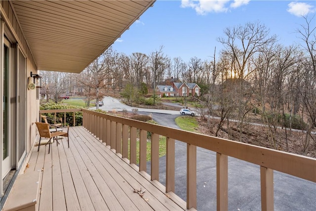 wooden terrace featuring driveway