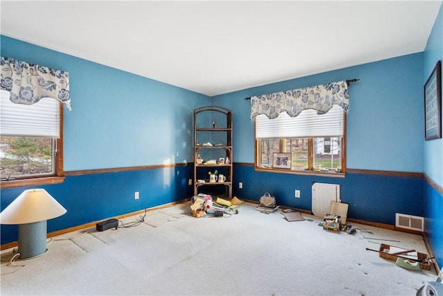 interior space with visible vents, baseboards, and carpet flooring