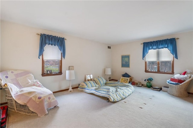 bedroom featuring visible vents, baseboards, and carpet floors