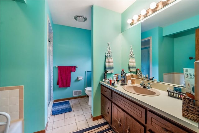 bathroom featuring vanity, baseboards, visible vents, tile patterned floors, and toilet