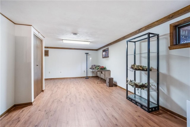 empty room with baseboards, wood finished floors, and ornamental molding