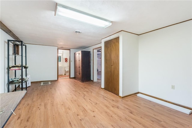 empty room with visible vents, baseboards, and light wood-style flooring