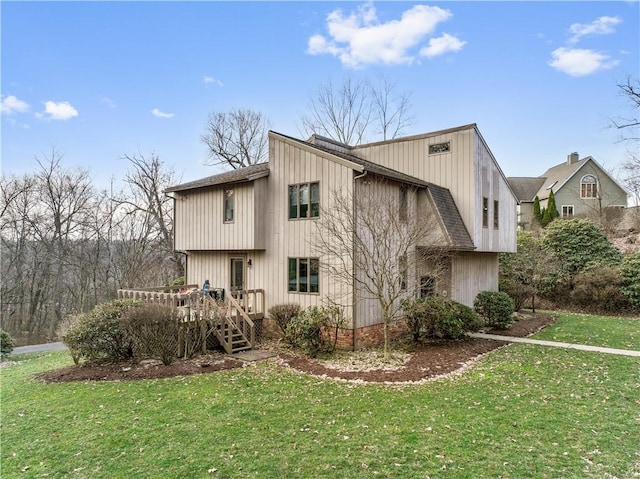 back of house with a deck and a yard