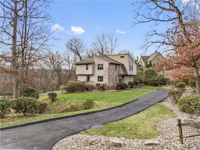 view of side of home with a yard