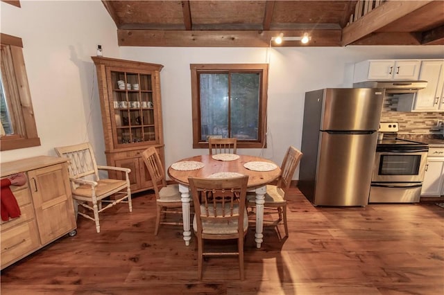 dining area featuring beamed ceiling and wood finished floors