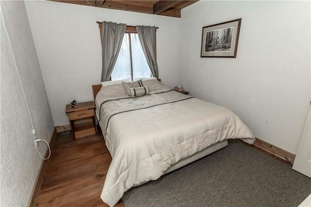 bedroom featuring wood finished floors and baseboards