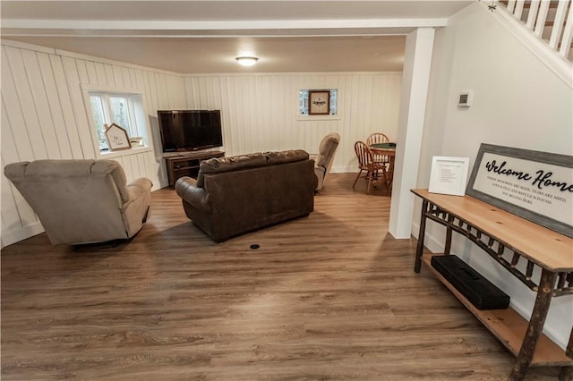 living room featuring stairs and wood finished floors