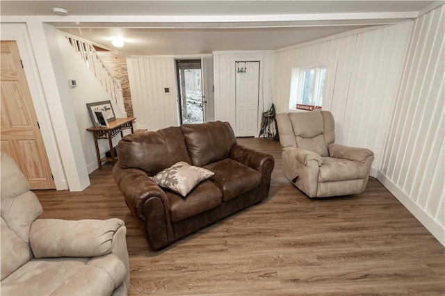 living room with stairs, wood finished floors, and baseboards