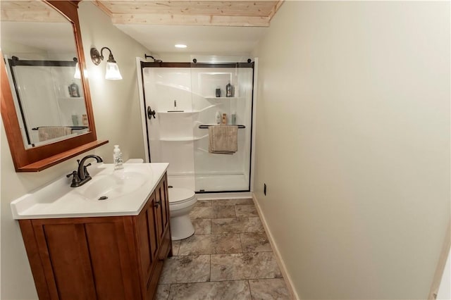 full bath with vanity, a shower stall, toilet, and baseboards