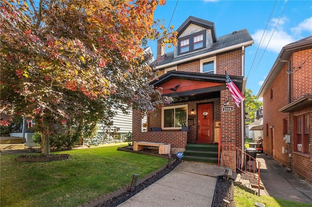 traditional style home featuring a front lawn and brick siding