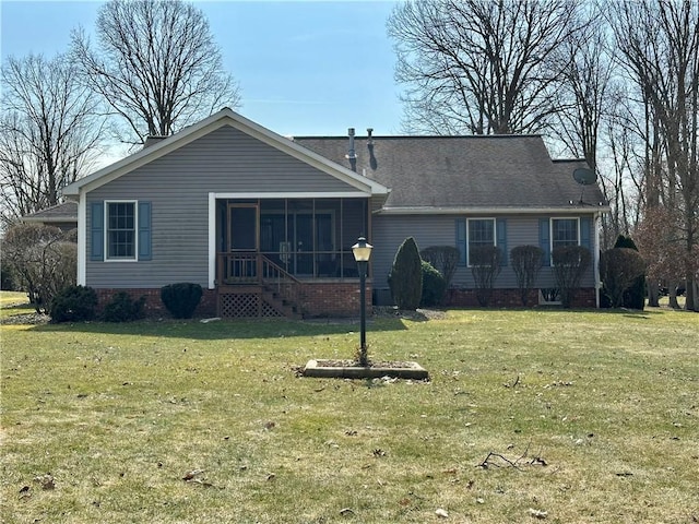 rear view of house with a yard and a sunroom