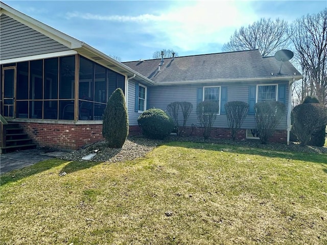 view of front facade featuring a front yard and a sunroom