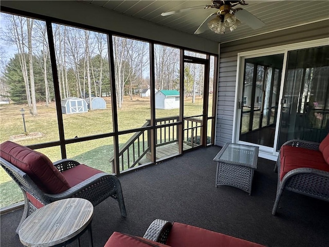 sunroom / solarium featuring ceiling fan