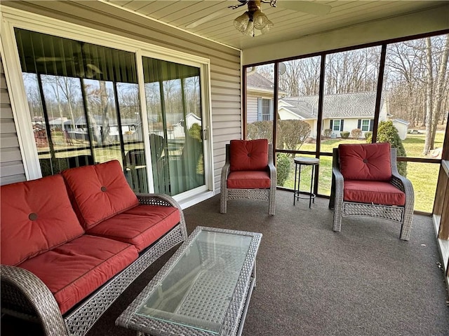 sunroom with ceiling fan and wooden ceiling