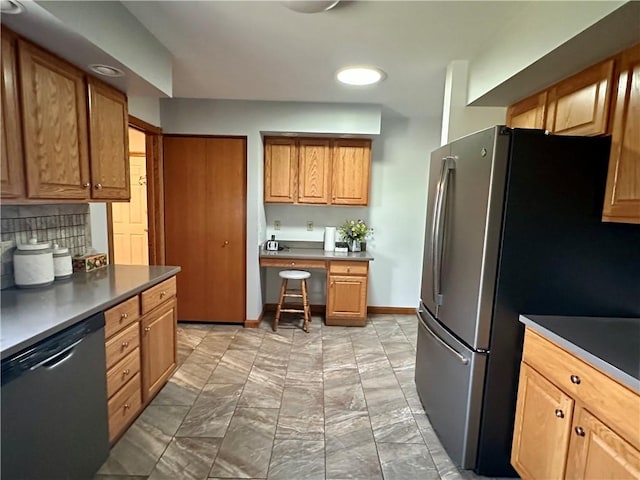 kitchen featuring dark countertops, baseboards, tasteful backsplash, and appliances with stainless steel finishes