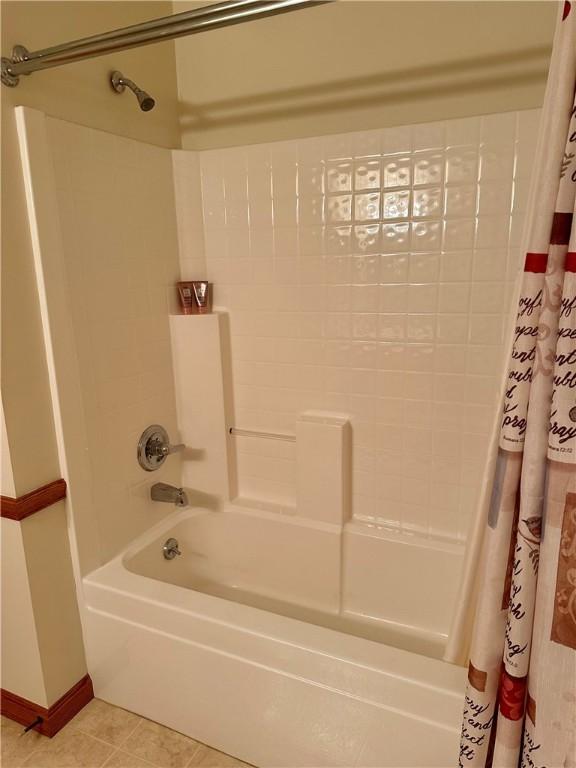 full bath with tile patterned floors and shower / tub combo