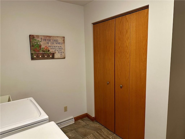 laundry area featuring a baseboard heating unit, baseboards, washer / dryer, and laundry area