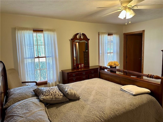 bedroom with multiple windows and ceiling fan