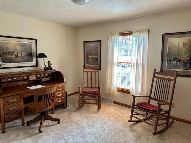 carpeted home office with visible vents, baseboards, and a textured ceiling