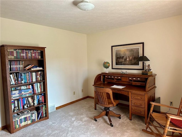 carpeted office space featuring visible vents, a textured ceiling, and baseboards