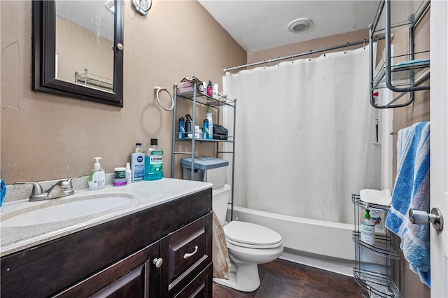 bathroom featuring shower / bath combination with curtain, toilet, and vanity