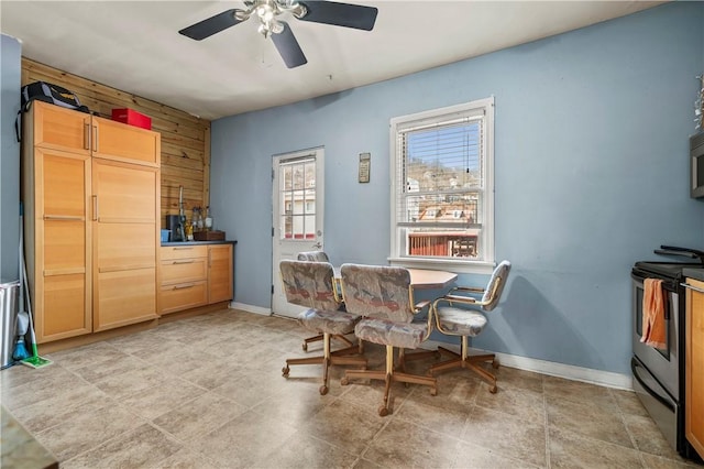 dining area featuring baseboards and ceiling fan