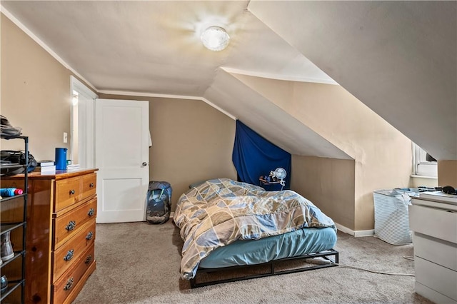 carpeted bedroom with baseboards and vaulted ceiling