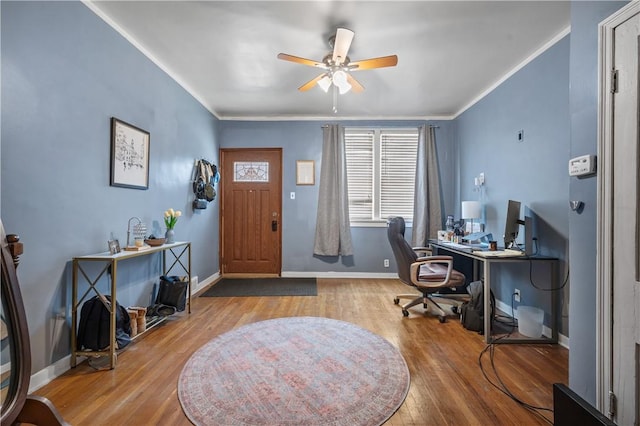 office space with baseboards, wood finished floors, and crown molding