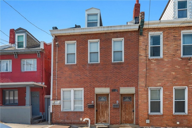 view of property featuring brick siding