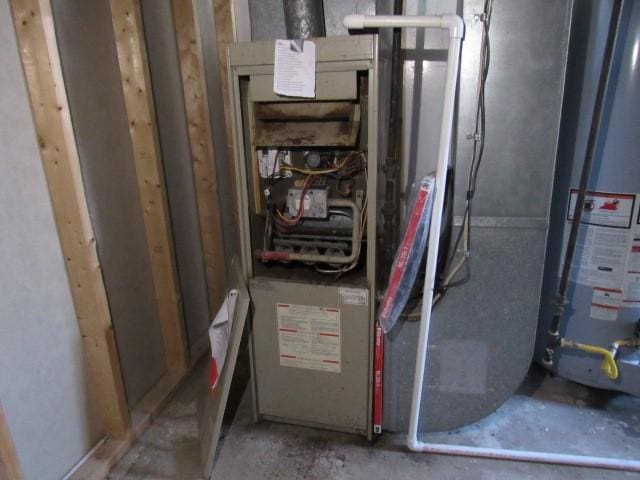 utility room featuring gas water heater