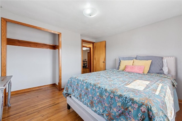 bedroom featuring baseboards and wood finished floors