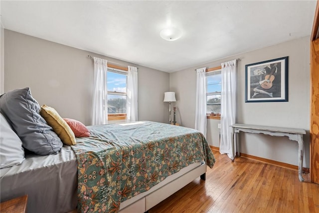 bedroom with light wood-type flooring and baseboards