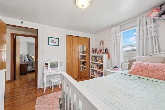 bedroom featuring a closet and light wood-type flooring