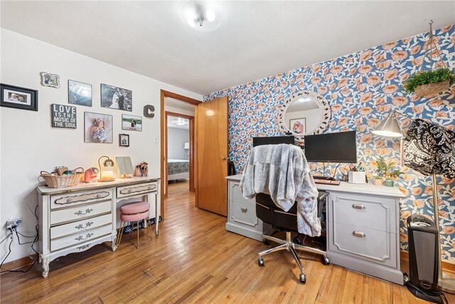 office featuring light wood-style flooring and wallpapered walls