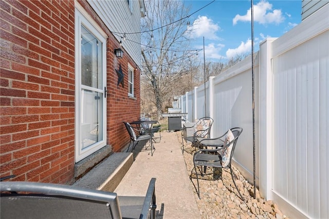 view of patio featuring fence