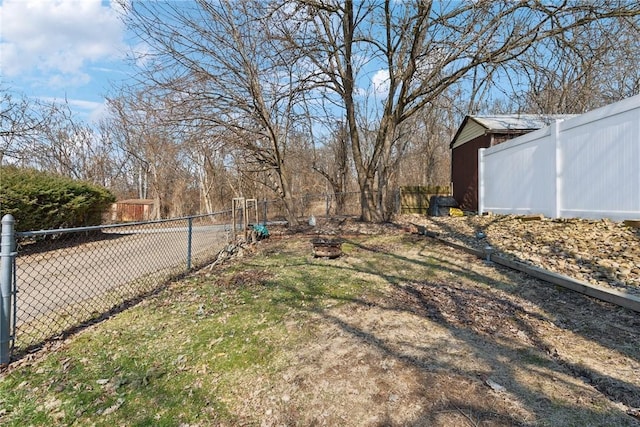 view of yard with an outdoor fire pit and fence private yard