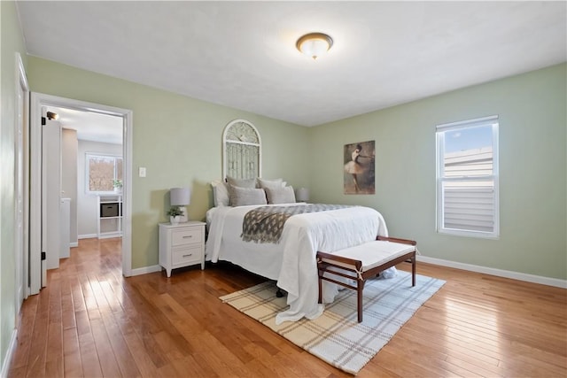 bedroom with hardwood / wood-style flooring and baseboards