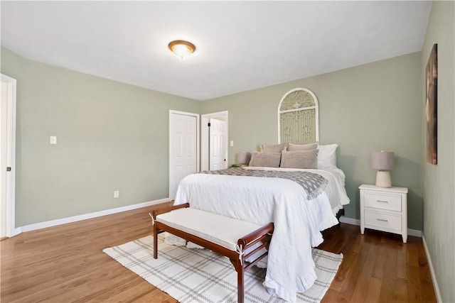 bedroom with baseboards and wood finished floors