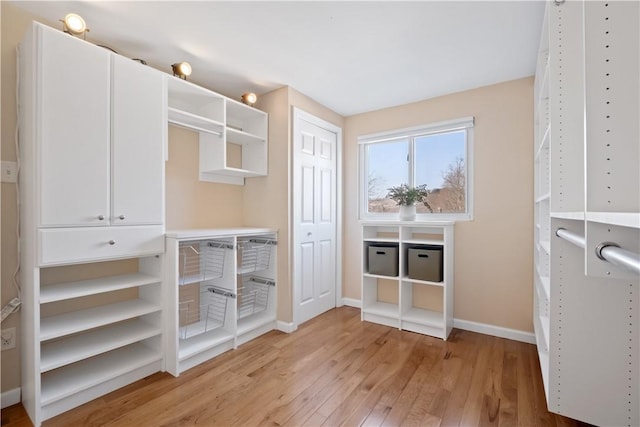 walk in closet featuring light wood-style flooring