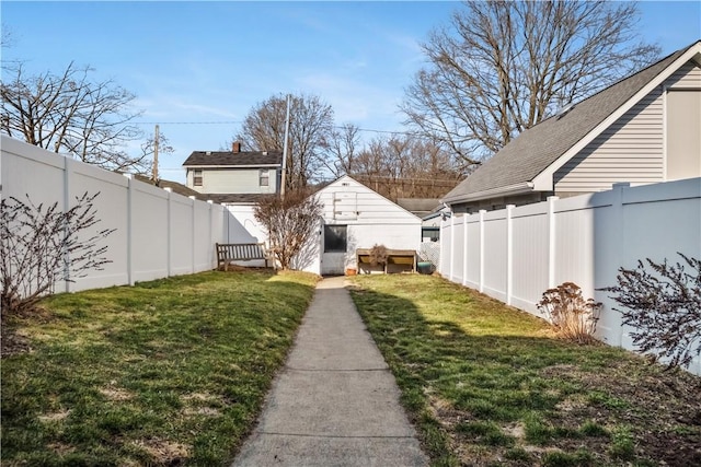 view of yard with an outdoor structure and a fenced backyard