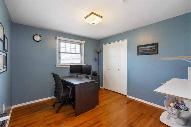 office with baseboards and wood finished floors