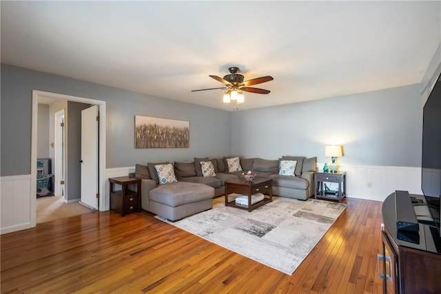 living room featuring wainscoting, ceiling fan, and hardwood / wood-style floors