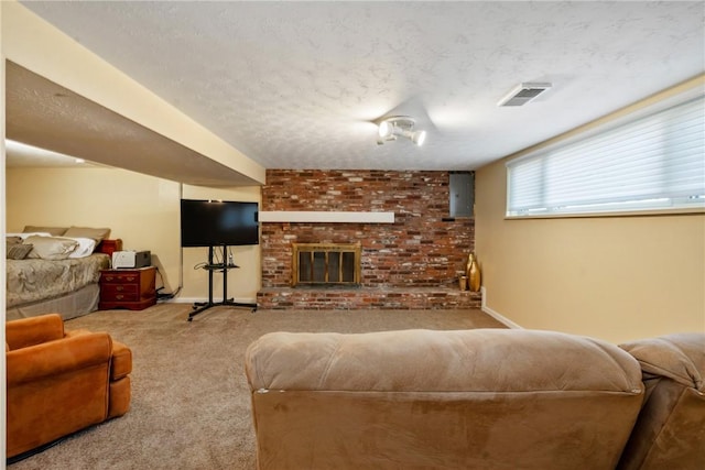 living area with visible vents, a textured ceiling, carpet floors, a fireplace, and baseboards