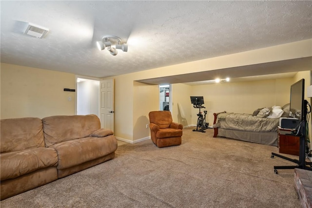 bedroom featuring baseboards, visible vents, a textured ceiling, and carpet