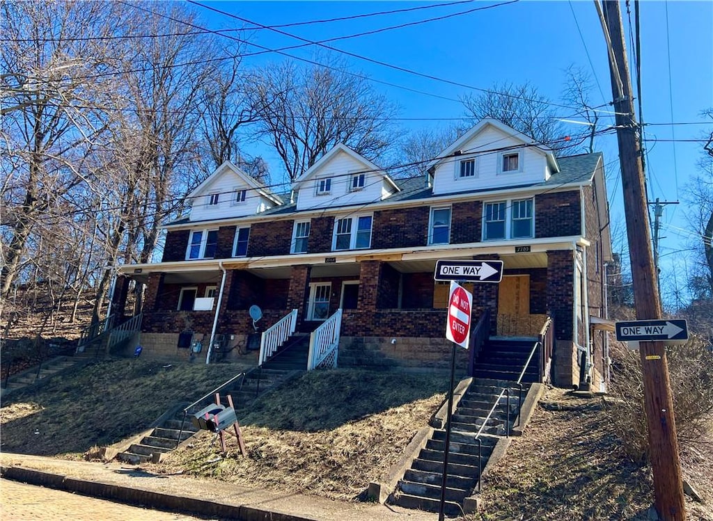 7700-7704 Stanton Ave, Swissvale, PA 15218 - view of front of home featuring stairs, a porch, and brick siding
