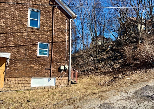 view of property exterior with brick siding