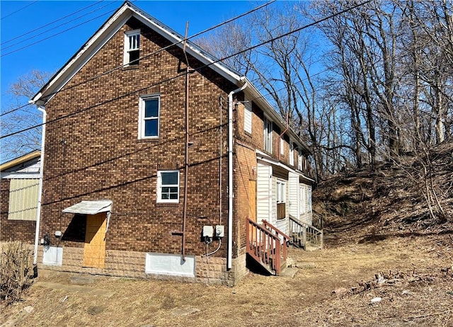 view of home's exterior featuring entry steps and brick siding